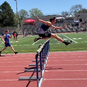 Boy jumps hurdle